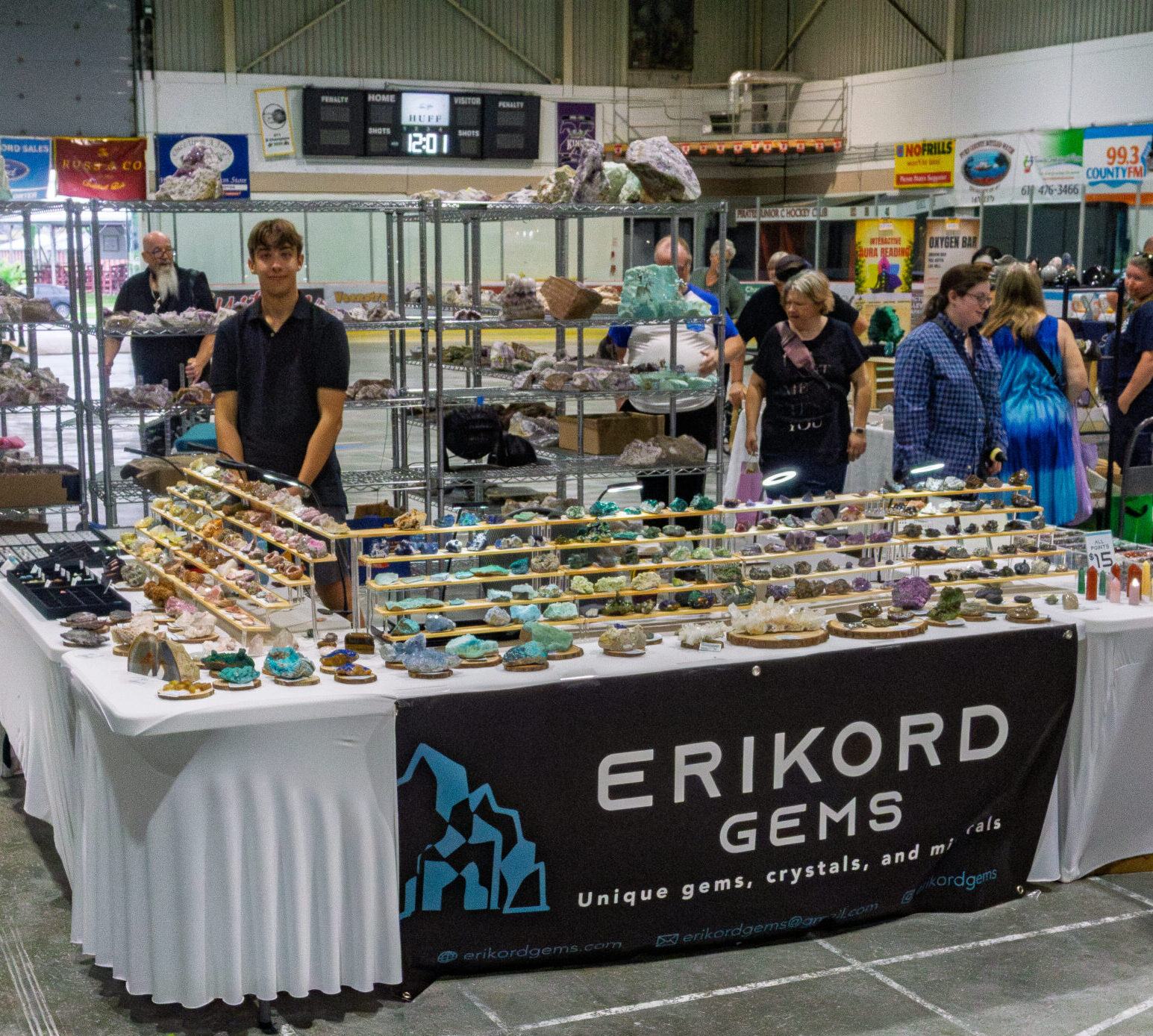 Vendors and attendees at a Rock and Gem Expo event booth