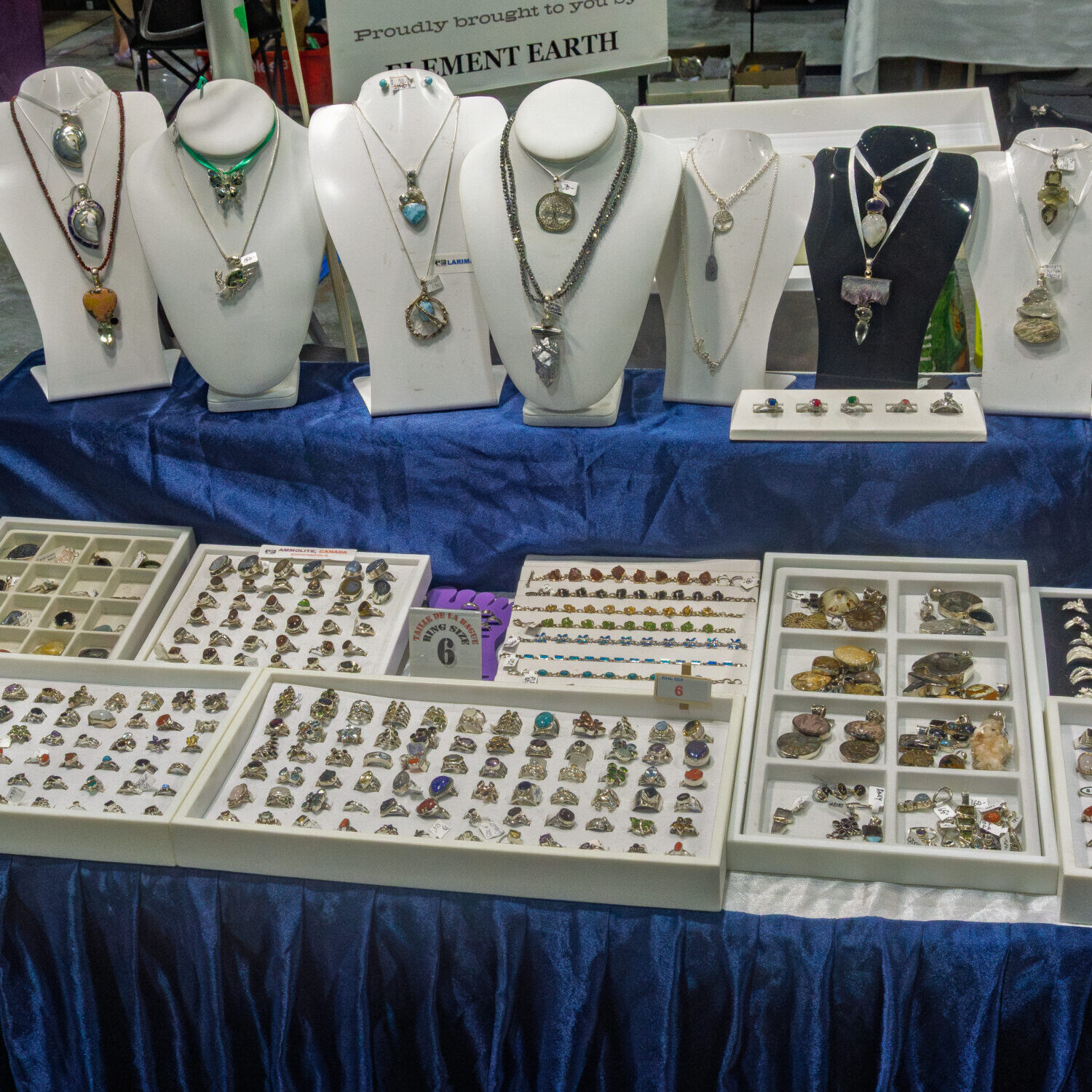 Handcrafted gemstone necklaces and jewellery on display at a Kitchener Rock and Gem Expo vendor booth