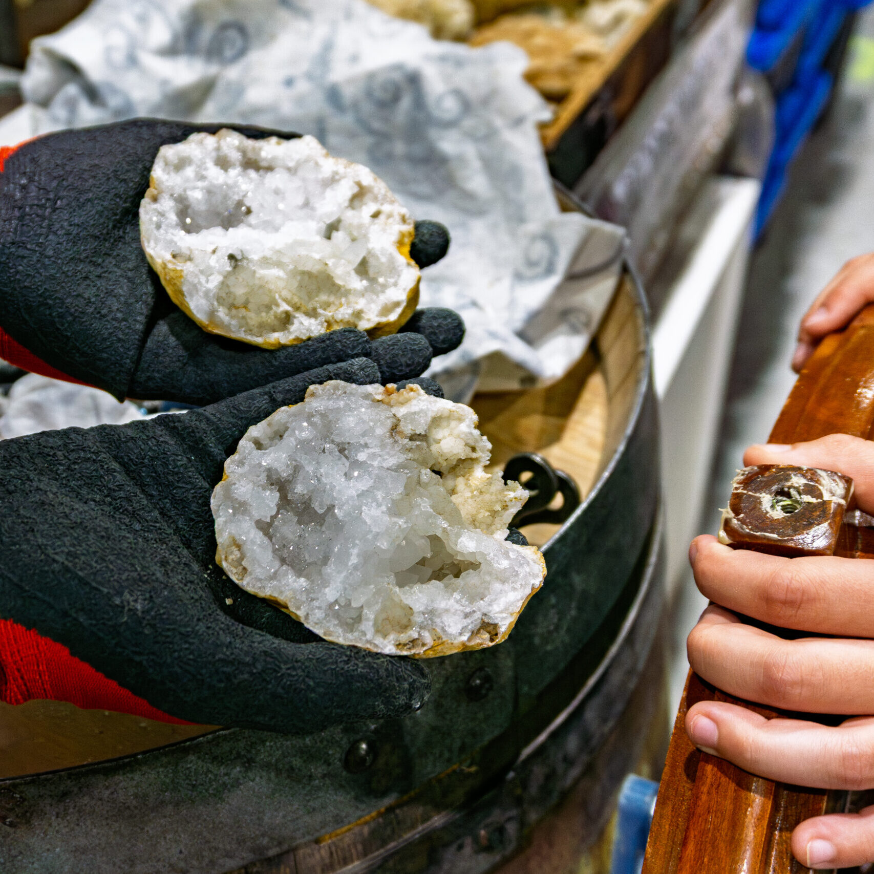 Freshly cracked geodes revealing crystal formations at the Rock and Gem Expo geode cracking station in Kitchener
